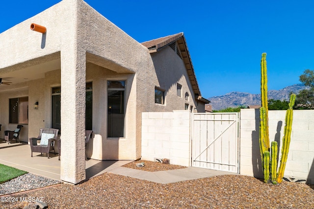 view of property exterior featuring a mountain view and a patio