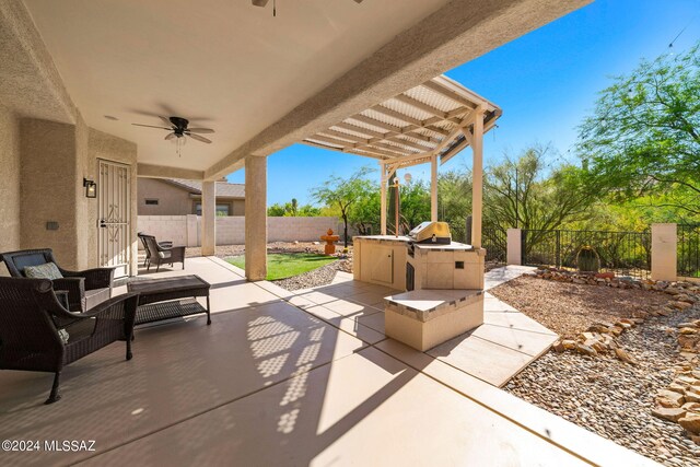 view of patio / terrace featuring an outdoor kitchen and ceiling fan