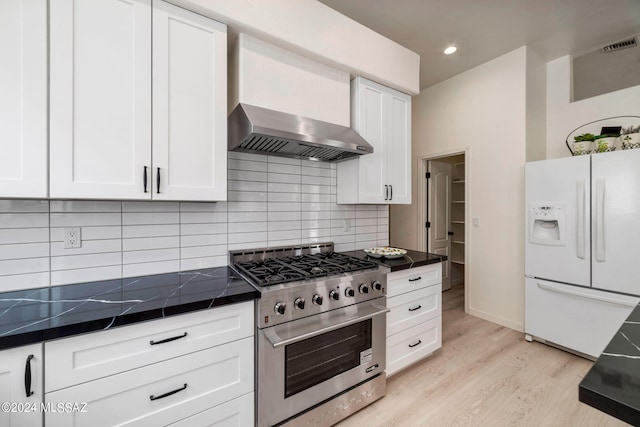 kitchen with white cabinets, light hardwood / wood-style floors, high end stove, and white fridge with ice dispenser