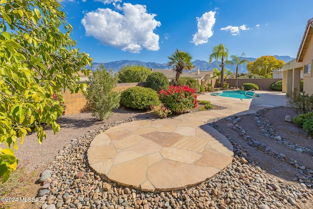 view of patio featuring a fenced in pool and a mountain view