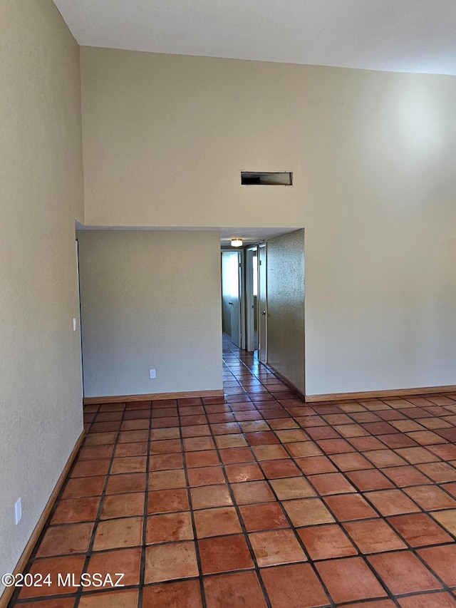 empty room with dark tile patterned floors