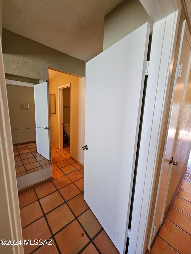 corridor featuring light tile patterned floors