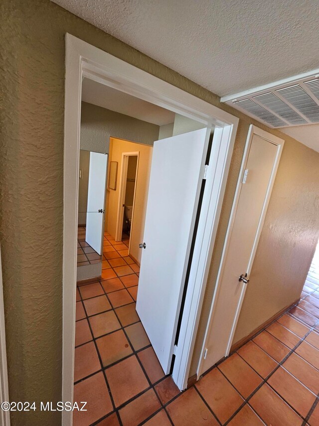 corridor with light tile patterned flooring