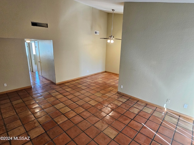 empty room featuring tile patterned floors and ceiling fan