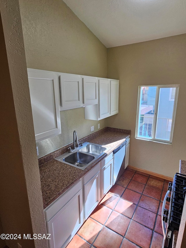 kitchen featuring dishwashing machine, white cabinetry, sink, and lofted ceiling