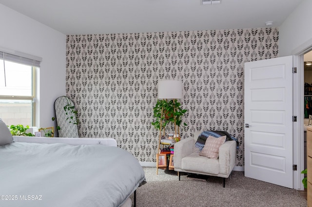 bedroom featuring wallpapered walls, carpet flooring, baseboards, and visible vents