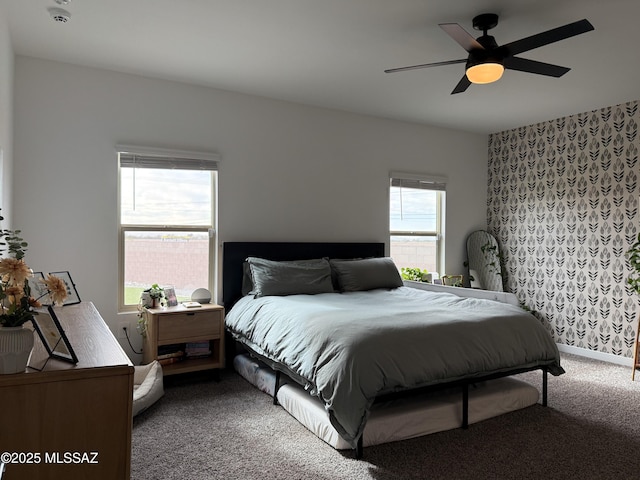 bedroom featuring baseboards, wallpapered walls, a ceiling fan, and carpet floors