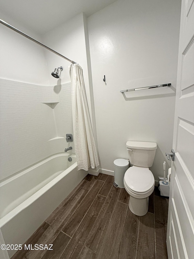 bathroom with shower / tub combo with curtain and toilet