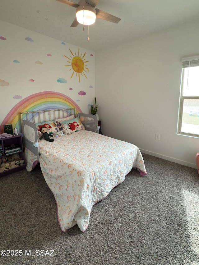 carpeted bedroom featuring baseboards and ceiling fan