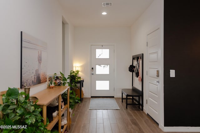 foyer entrance featuring wood finished floors, recessed lighting, a healthy amount of sunlight, and visible vents