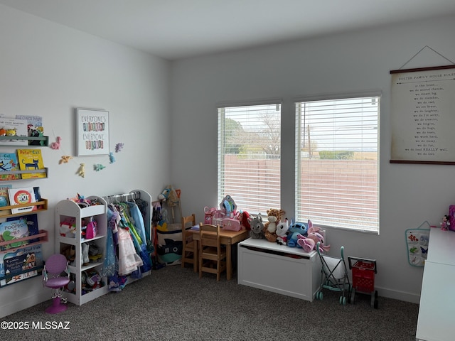 game room with dark colored carpet