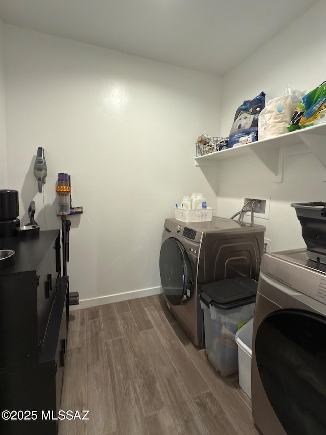 laundry room featuring independent washer and dryer and dark wood-type flooring