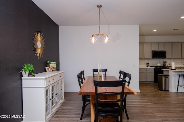 dining room with a chandelier and dark hardwood / wood-style floors