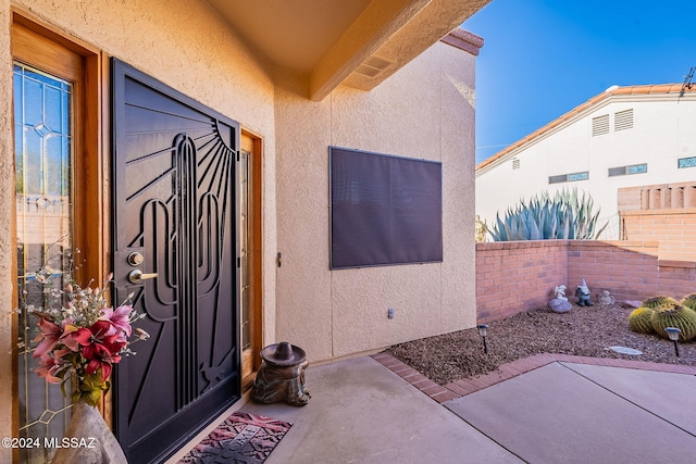 property entrance featuring a patio