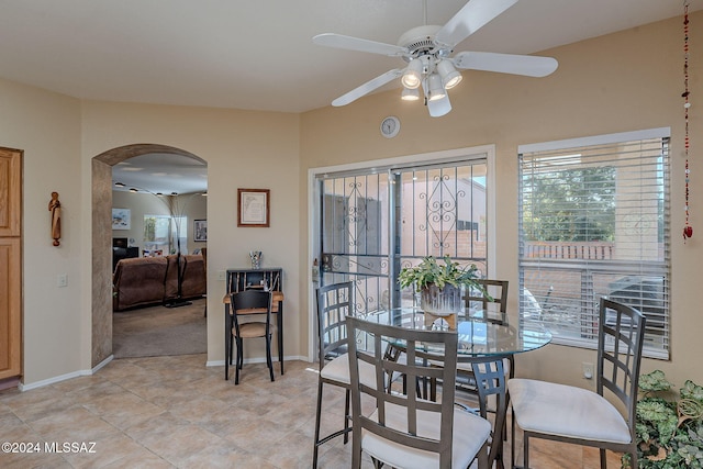 dining space featuring light tile patterned floors and ceiling fan