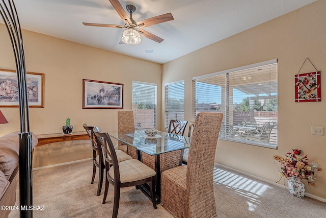 carpeted dining room featuring ceiling fan