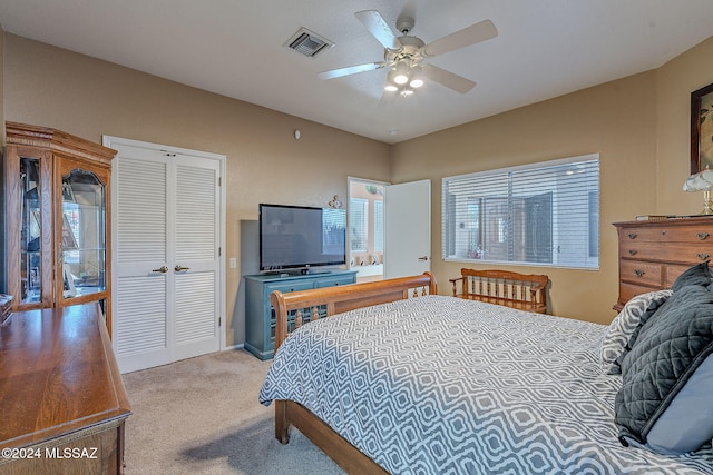 carpeted bedroom featuring ceiling fan and a closet