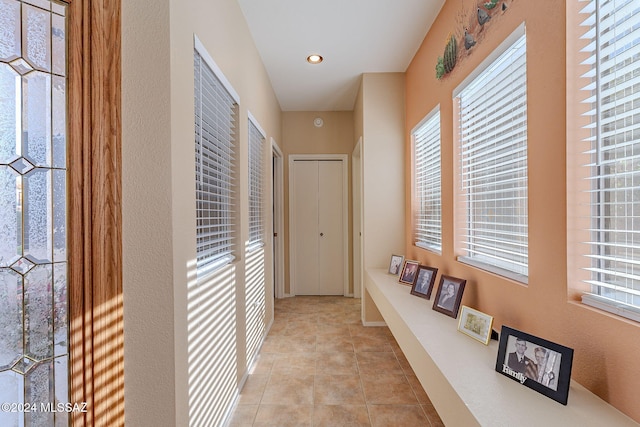 hall with light tile patterned flooring