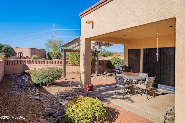 view of patio with a pergola and grilling area