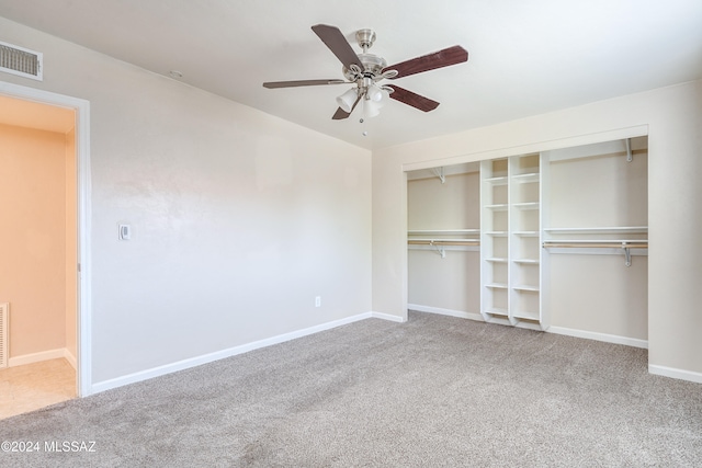 unfurnished bedroom featuring carpet flooring, ceiling fan, and a closet