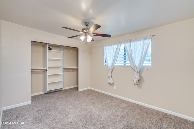 unfurnished bedroom featuring ceiling fan, a closet, and carpet floors