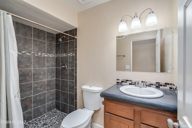 bathroom with tasteful backsplash, vanity, a shower with shower curtain, and toilet