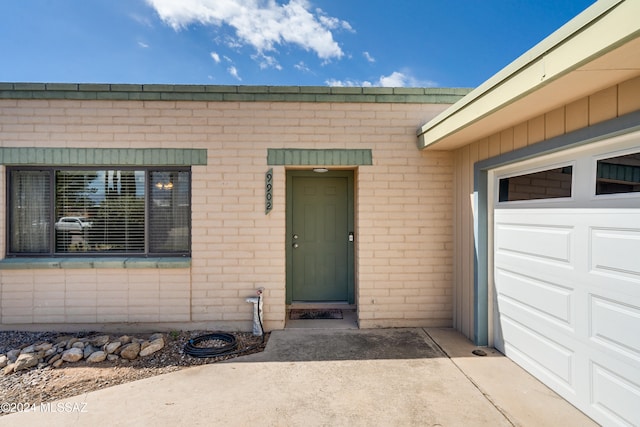 view of exterior entry featuring a garage