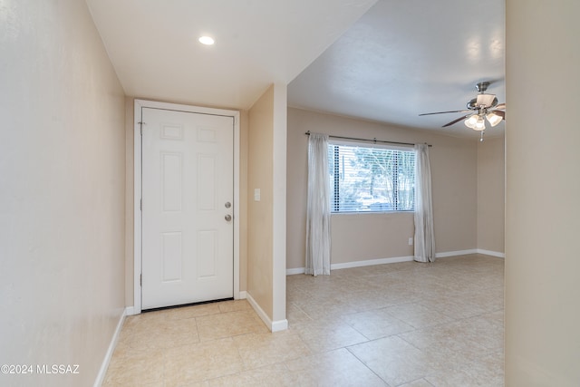 foyer entrance with light tile patterned floors and ceiling fan