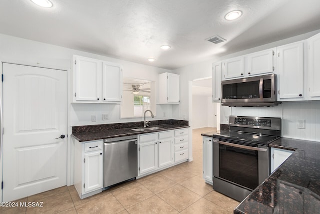 kitchen featuring sink, white cabinets, and appliances with stainless steel finishes