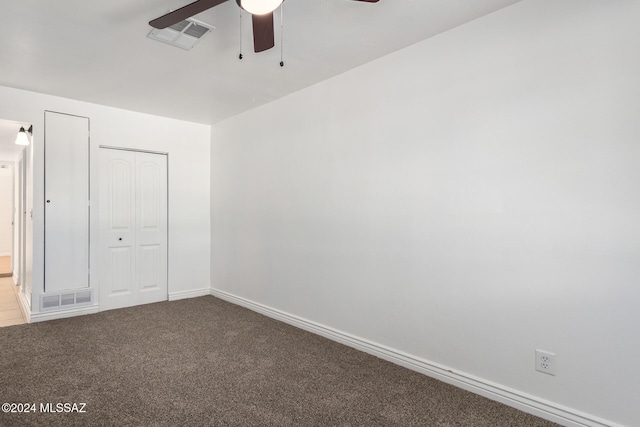 unfurnished bedroom with carpet floors, a closet, and ceiling fan