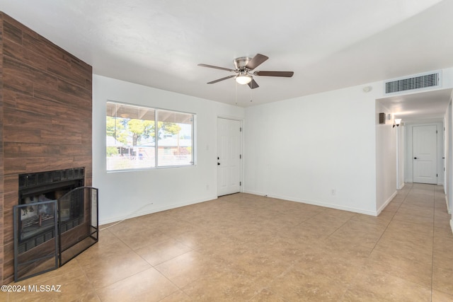 unfurnished living room with ceiling fan and a fireplace