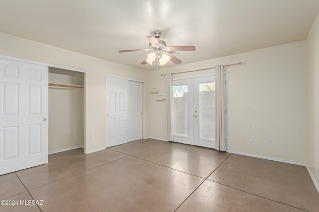 unfurnished bedroom featuring ceiling fan, multiple closets, and french doors