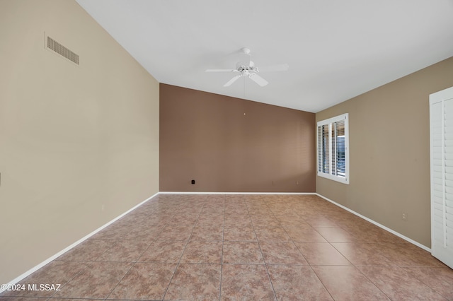 tiled empty room featuring ceiling fan