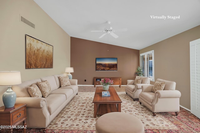 living room with ceiling fan and lofted ceiling