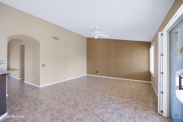 spare room with ceiling fan and light tile patterned flooring