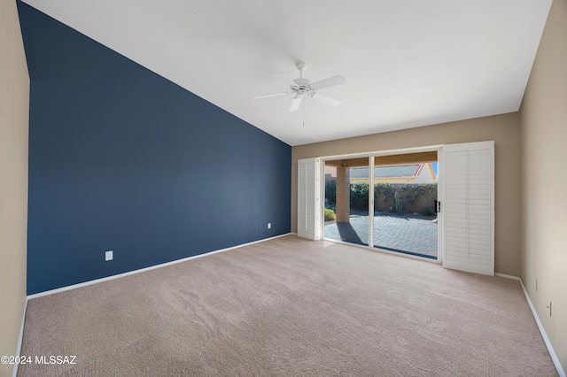 carpeted empty room featuring ceiling fan