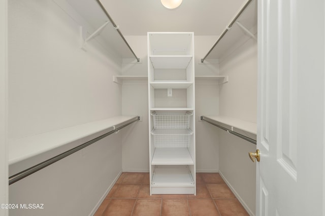 spacious closet featuring light tile patterned floors