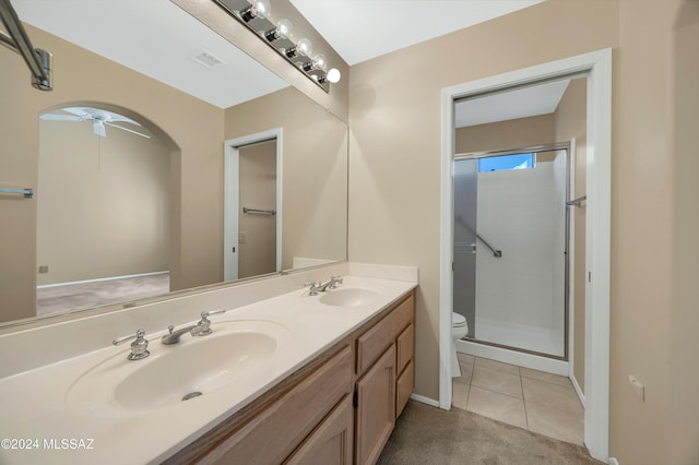 bathroom featuring tile patterned floors, ceiling fan, toilet, and walk in shower