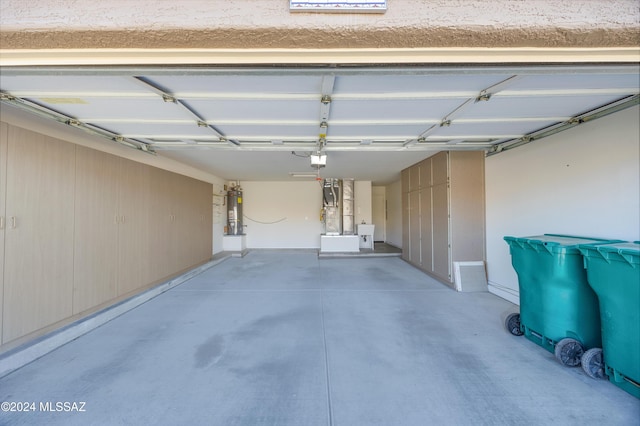 garage featuring strapped water heater and a garage door opener