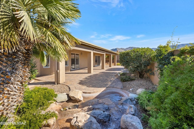 exterior space with a patio area and a mountain view