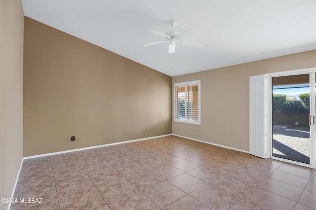 tiled spare room with a wealth of natural light and ceiling fan