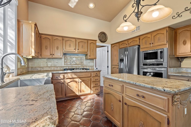 kitchen with a kitchen island, appliances with stainless steel finishes, pendant lighting, tasteful backsplash, and sink