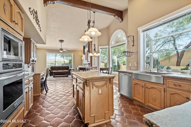 kitchen with a kitchen island, appliances with stainless steel finishes, sink, hanging light fixtures, and beam ceiling