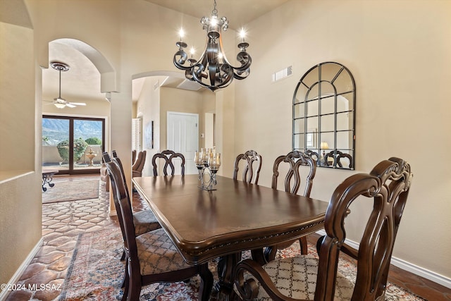 dining area with ceiling fan with notable chandelier