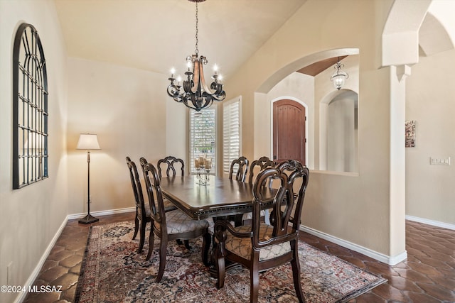 dining space with vaulted ceiling and a chandelier