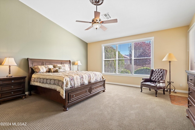 carpeted bedroom with ceiling fan and vaulted ceiling