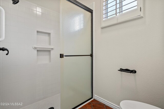 bathroom with toilet and walk in shower