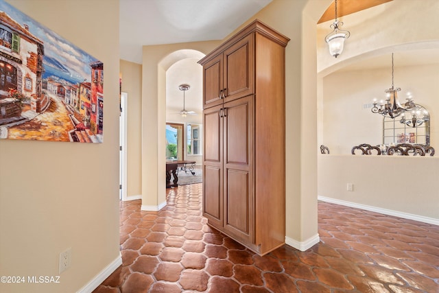 hallway with an inviting chandelier