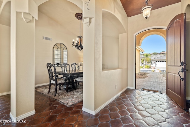 entrance foyer featuring lofted ceiling and a notable chandelier