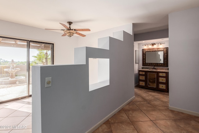 hall with tile patterned flooring and sink